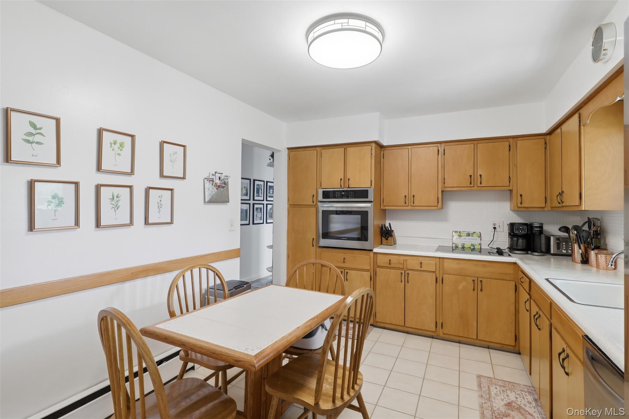 24 Beatty Road Wappingers Falls, NY 12590 - Photo 11 of 36 a kitchen with stainless steel appliances granite countertop a sink a stove a dining table and chairs