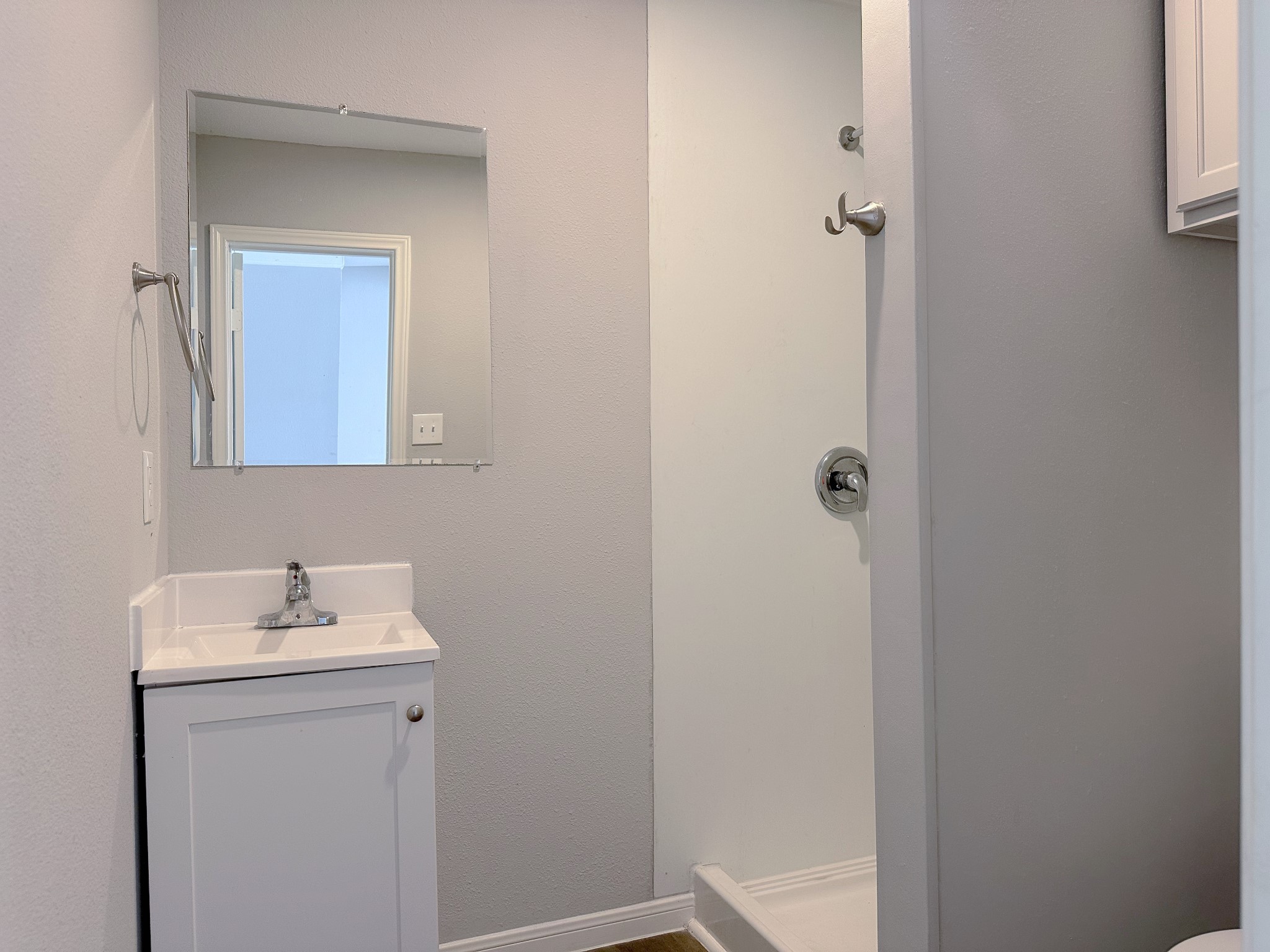 2704 Brewster Street Houston, TX 77026 - Photo 6 of 10 a bathroom with a sink a mirror and vanity