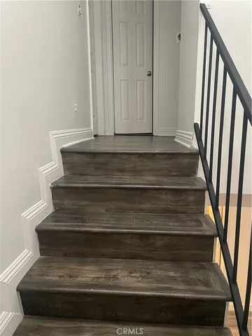 a bathroom with a granite countertop bathtub sink vanity mirror and toilet