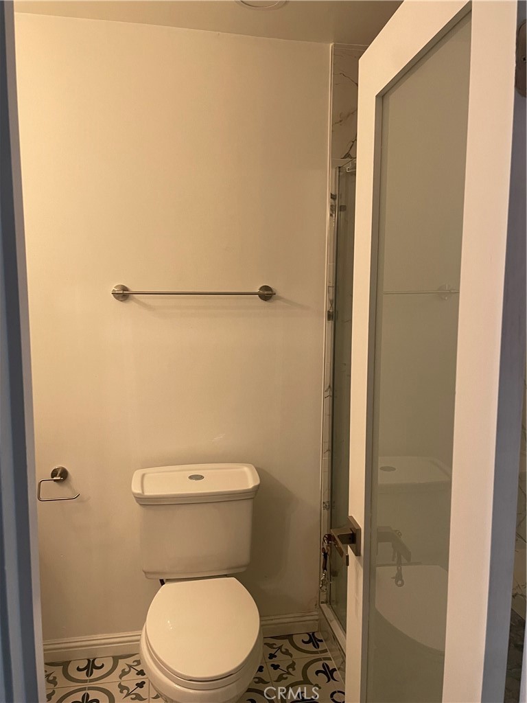 1707 Garvey Avenue, Unit 12 Alhambra, CA 91803 - Photo 18 of 22 a white toilet sitting next to a shower