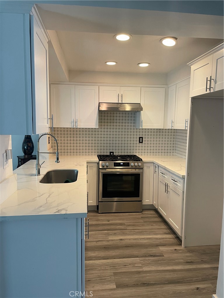 1707 Garvey Avenue, Unit 12 Alhambra, CA 91803 - Photo 7 of 22 a kitchen with a sink and a stove top oven