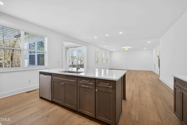 an empty room with wooden floor and entryway