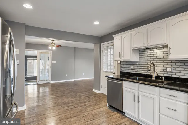 a kitchen with granite countertop a sink and cabinets