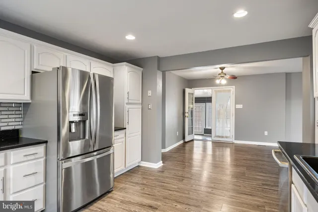 a kitchen with stainless steel appliances granite countertop a refrigerator and a sink