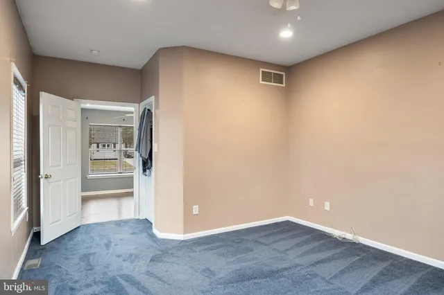 a view of hallway with wooden floor