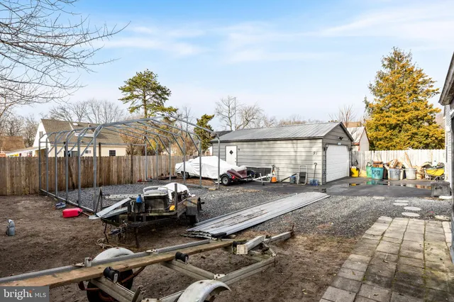a view of a patio with table and chairs and potted plants