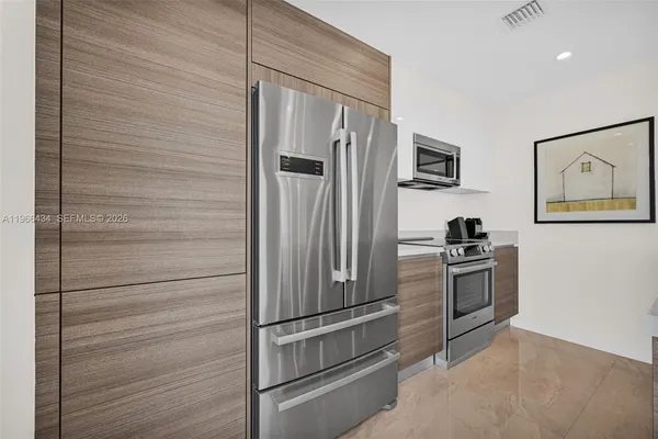 a large kitchen with a table and chairs