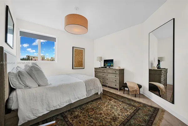 a bedroom with a bed and dresser