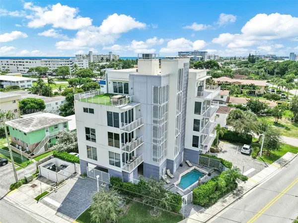 a living room with furniture a large window and a flat screen tv