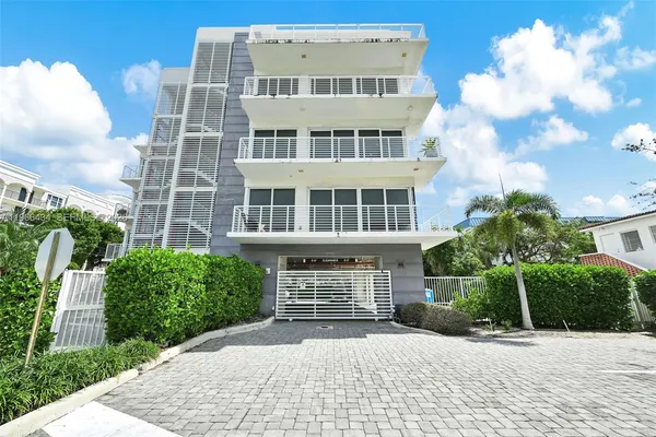 a front view of a building with a yard