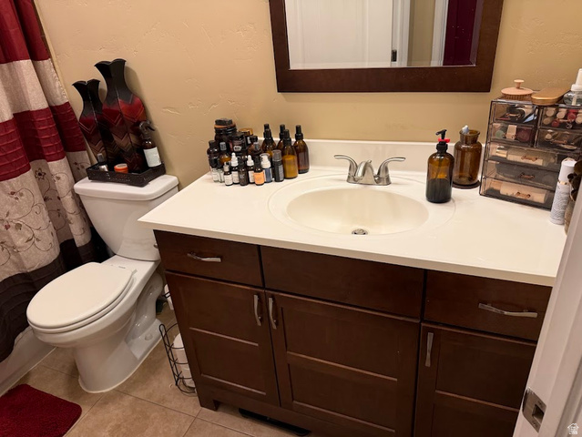 737 Wasatch Street Midvale, UT 84047 - Photo 8 of 29 Bathroom vanity featuring a white countertop with an integrated sink, a dark wood-finish cabinet with brushed nickel hardware, and a matching framed mirror