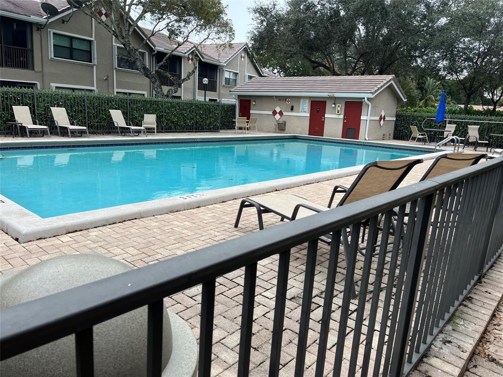 9641 Riverside Drive, Unit F1 Coral Springs, FL 33071 - Photo 17 of 18 a view of swimming pool with outdoor seating