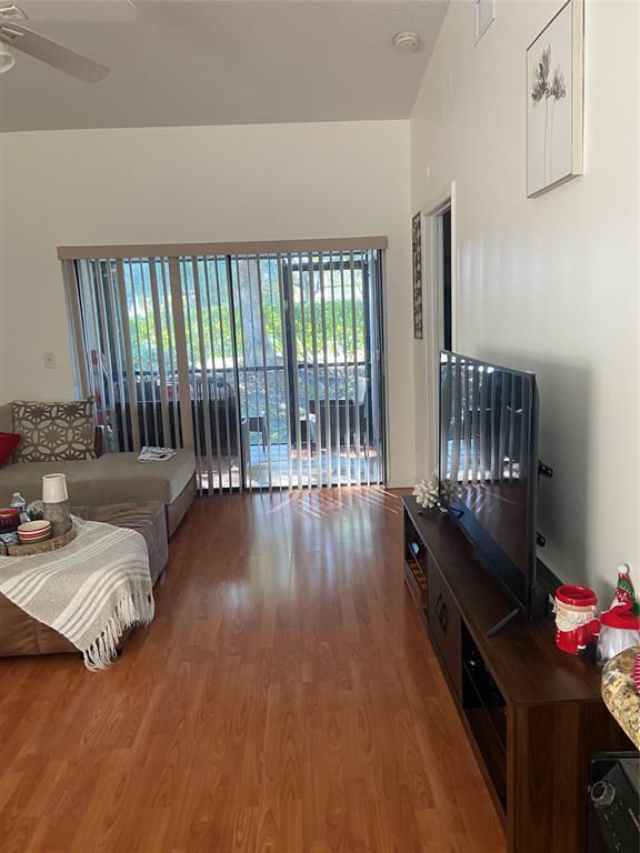 9641 Riverside Drive, Unit F1 Coral Springs, FL 33071 - Photo 4 of 18 a living room with furniture and a floor to ceiling window