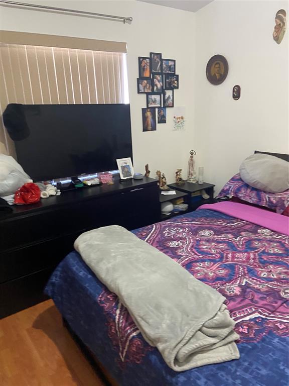 9641 Riverside Drive, Unit F1 Coral Springs, FL 33071 - Photo 6 of 18 a bedroom with a bed and a flat screen tv