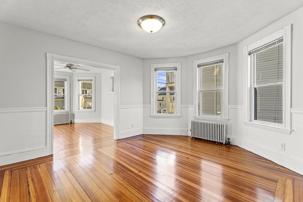 15 Sturgis Street Woburn, MA 01801 - Photo 11 of 38 an empty room with wooden floor and windows