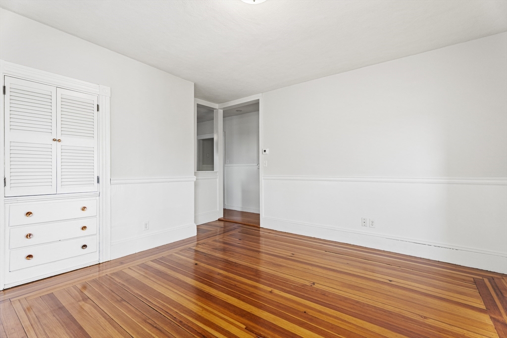 15 Sturgis Street Woburn, MA 01801 - Photo 12 of 38 wooden floor in an empty room