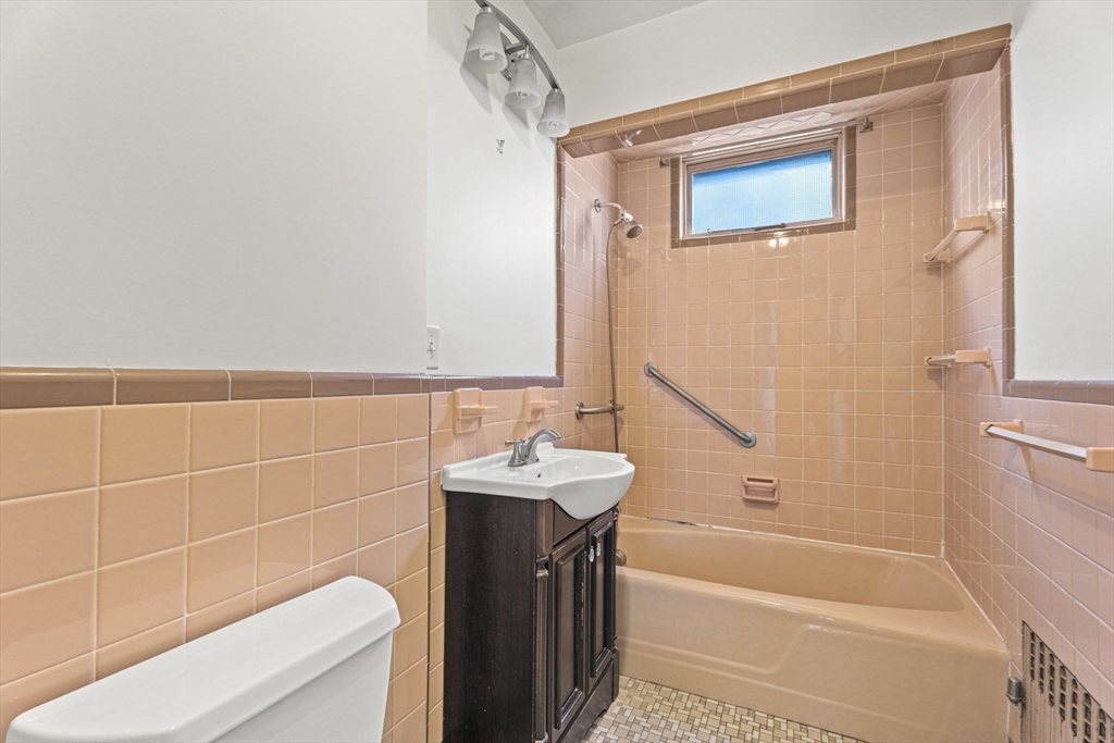 15 Sturgis Street Woburn, MA 01801 - Photo 14 of 38 a bathroom with a sink a toilet and shower