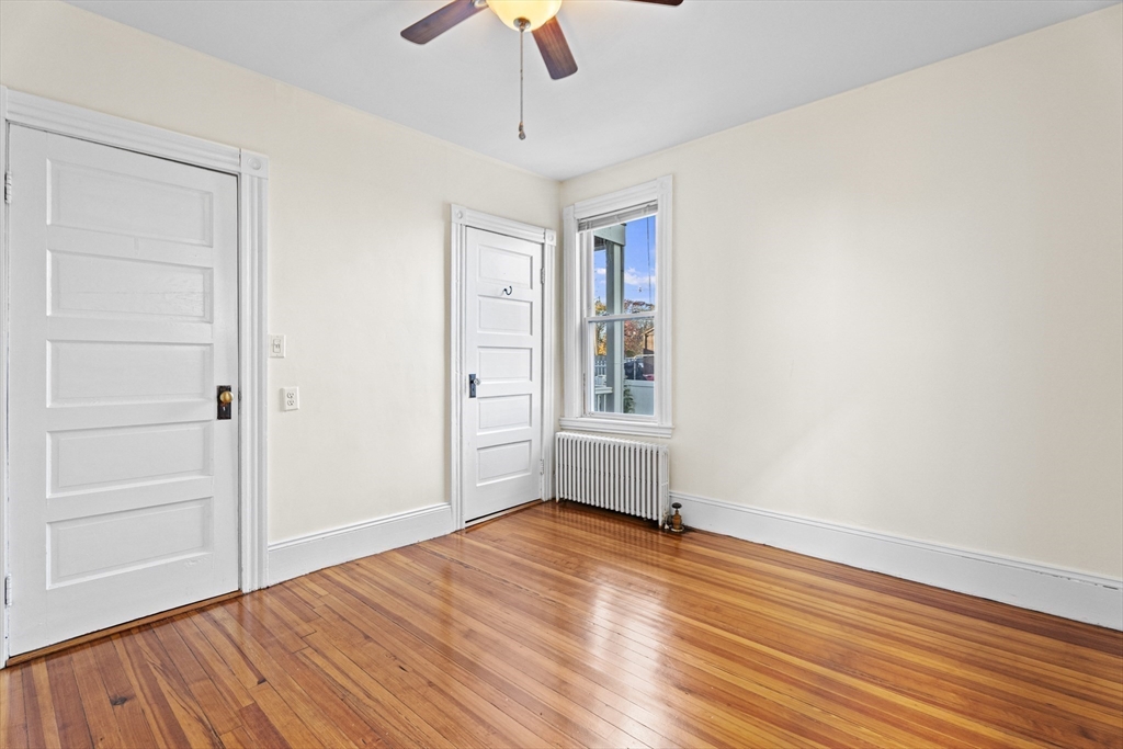 15 Sturgis Street Woburn, MA 01801 - Photo 16 of 38 a view of empty room with wooden floor and fan