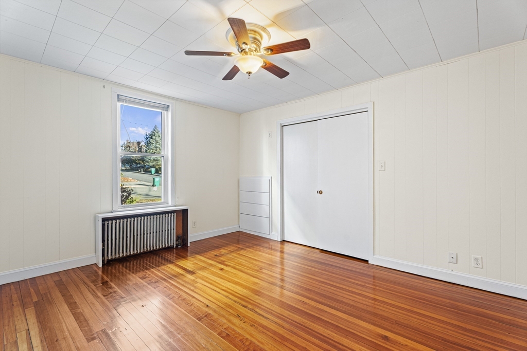 15 Sturgis Street Woburn, MA 01801 - Photo 17 of 38 an empty room with wooden floor and windows