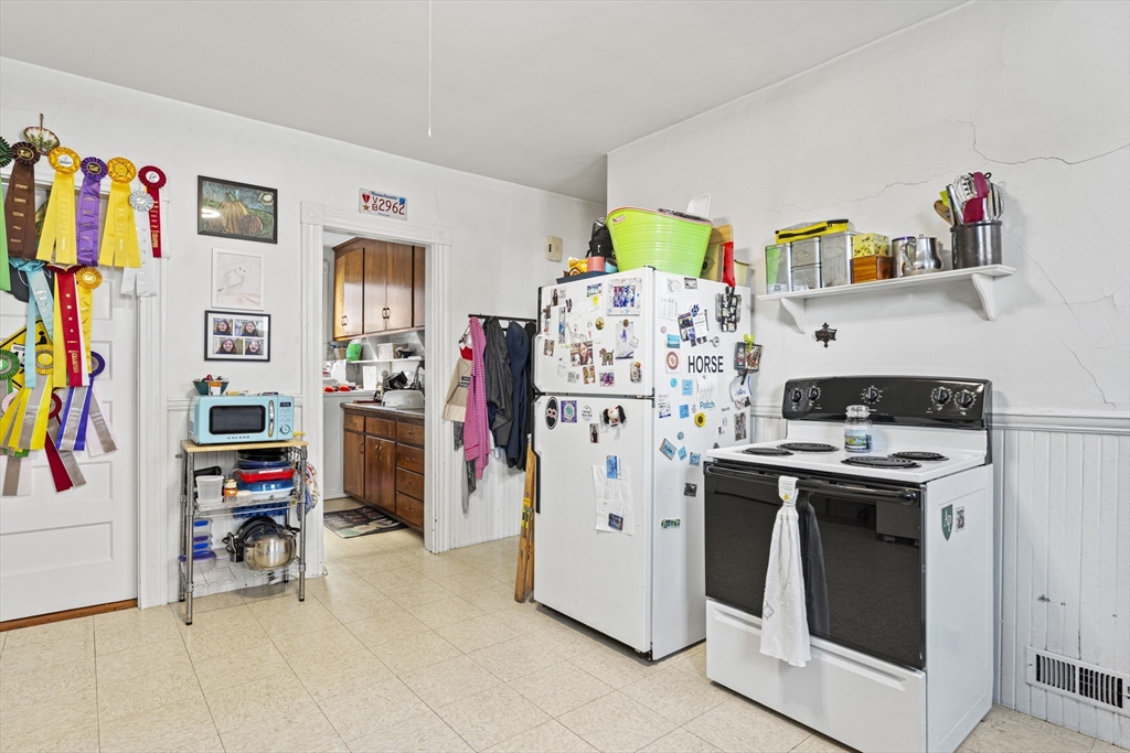 15 Sturgis Street Woburn, MA 01801 - Photo 19 of 38 a view of a kitchen with fridge and workspace