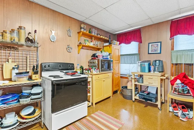 a kitchen with a refrigerator and a stove top oven