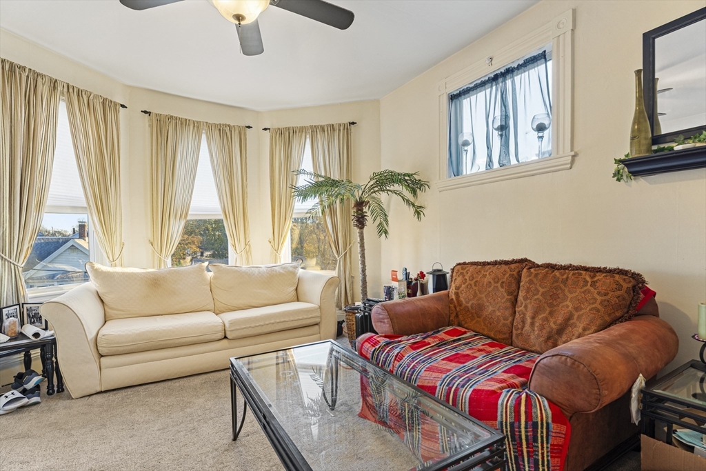15 Sturgis Street Woburn, MA 01801 - Photo 31 of 38 a living room with furniture a couch and a window