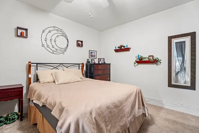 a bathroom with a sink a toilet and shower curtain