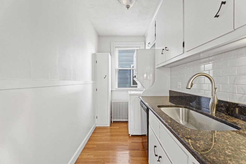15 Sturgis Street Woburn, MA 01801 - Photo 8 of 38 a kitchen with granite countertop a sink a stove and refrigerator