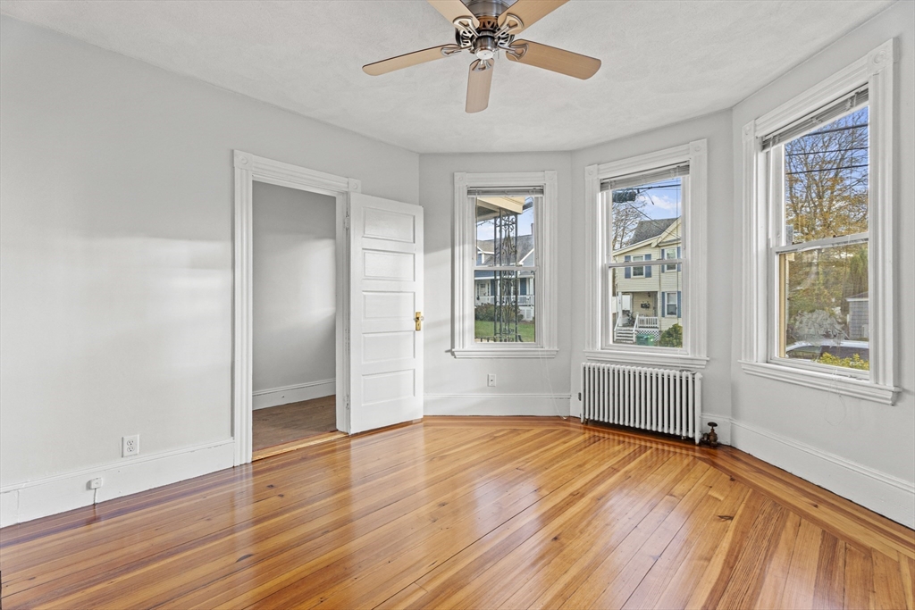 15 Sturgis Street Woburn, MA 01801 - Photo 9 of 38 a view of an empty room with wooden floor and a window