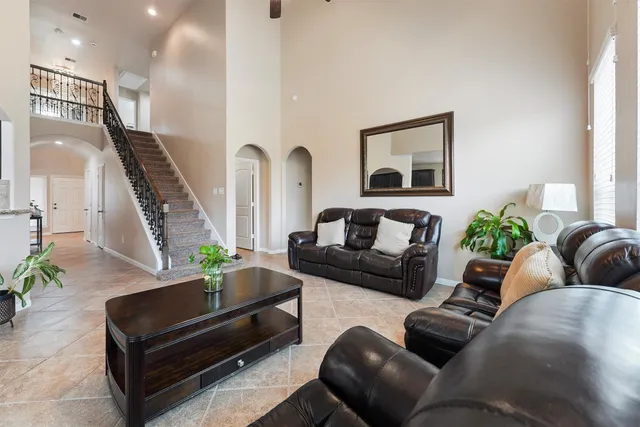 a living room with furniture and a potted plant