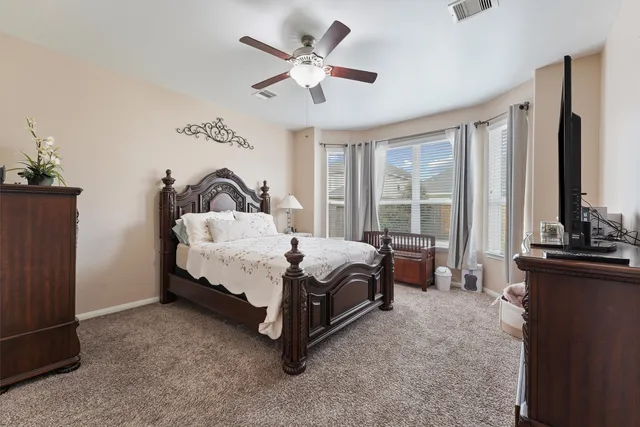 a bed sitting in a room next to a window