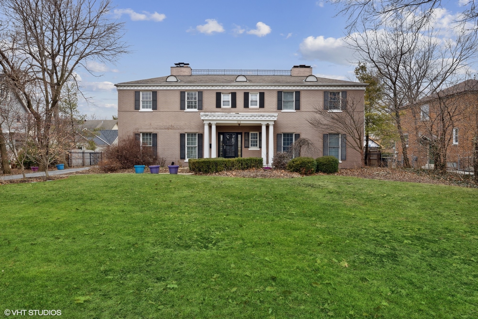258 Nuttall Road Riverside, IL 60546 - Photo 1 of 32 a front view of a house with a garden and trees