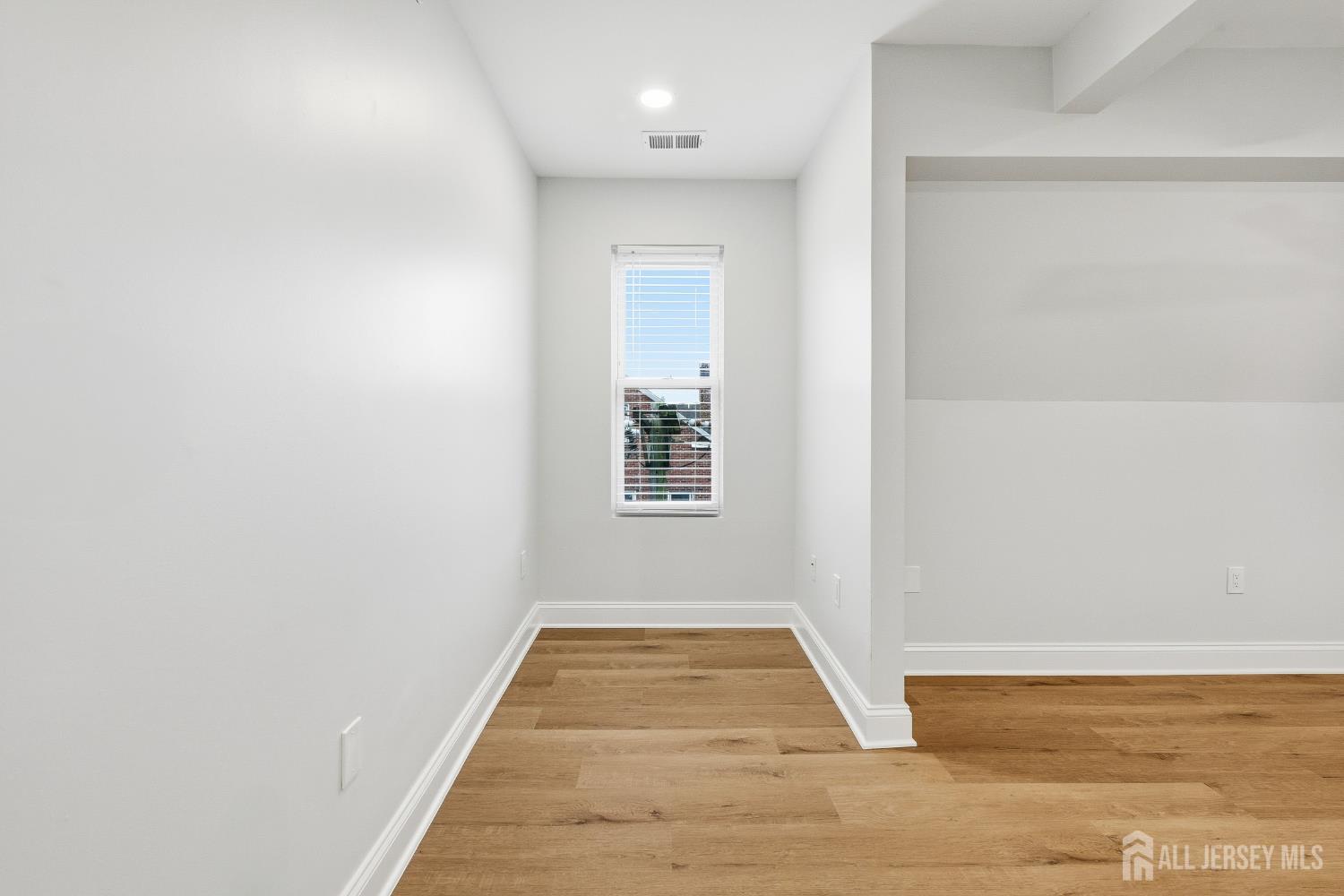 115 Remsen Avenue New Brunswick, NJ 08901 - Photo 22 of 38 a view of a hallway with wooden floor and a bathroom