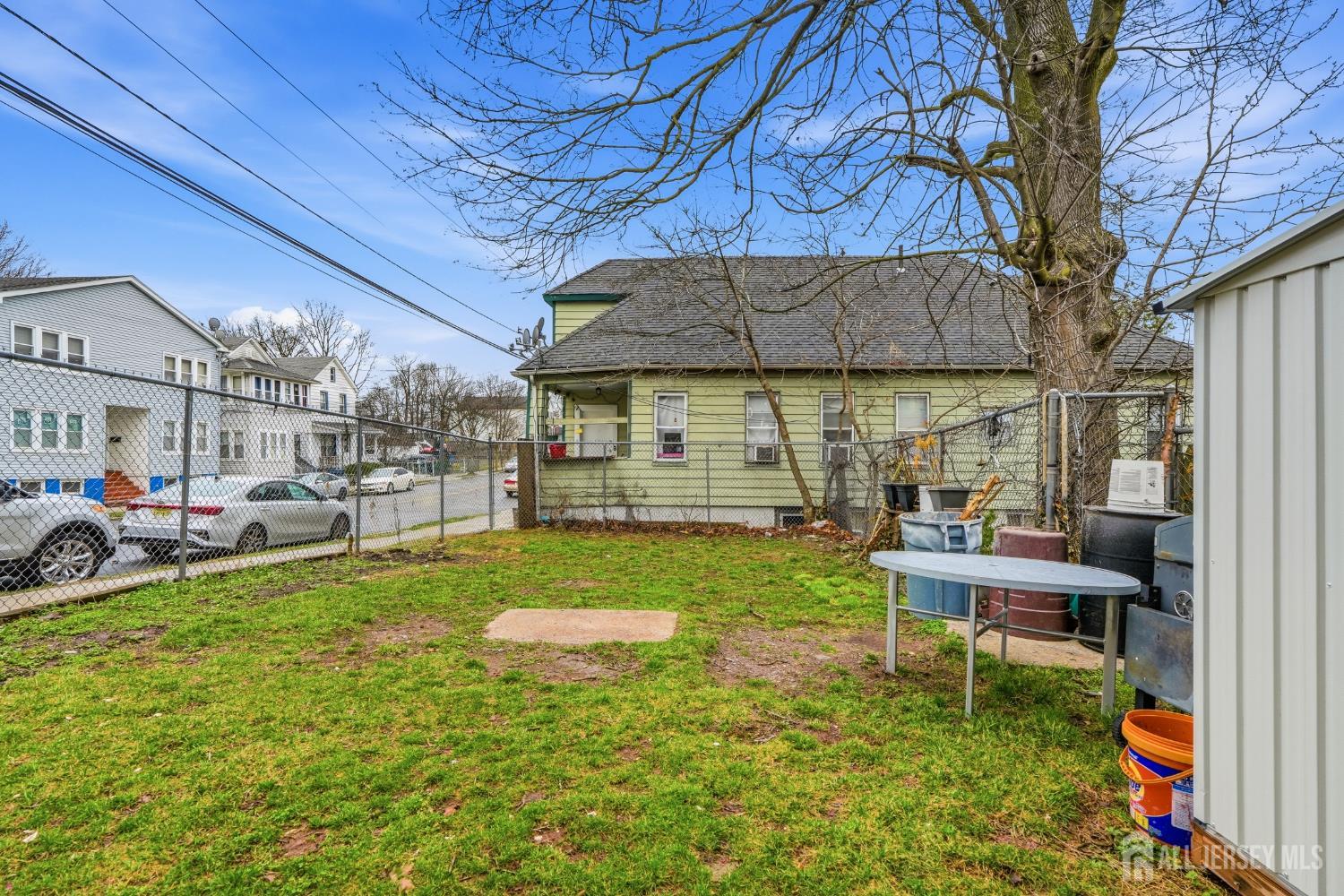 115 Remsen Avenue New Brunswick, NJ 08901 - Photo 29 of 38 a view of a backyard with table and chairs and potted plants