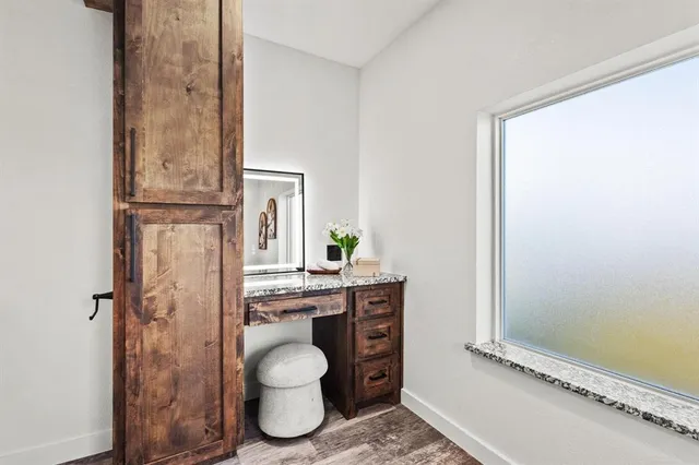 a bathroom with a granite countertop sink a toilet and a mirror