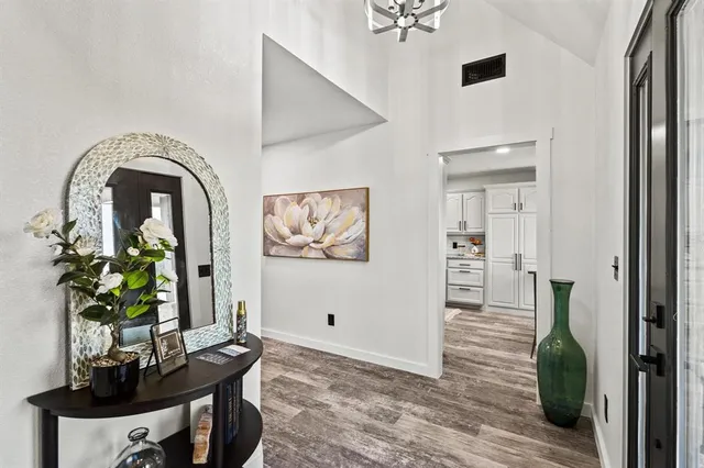 a view of a workspace room with furniture and wooden floor