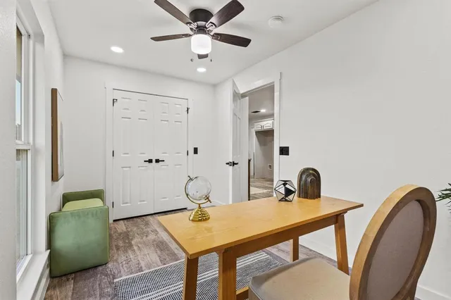 a view of a dining room with a table and chairs