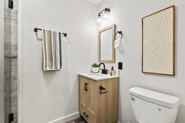 a bathroom with a toilet sink and mirror