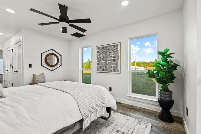 a bedroom with a bed and a potted plant
