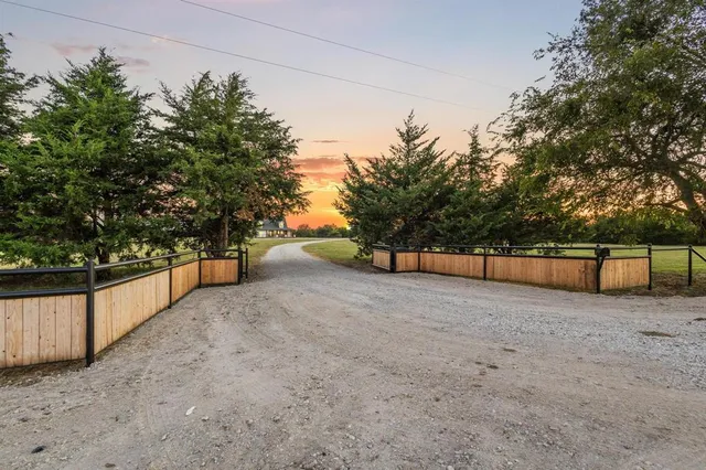a view of backyard with large trees