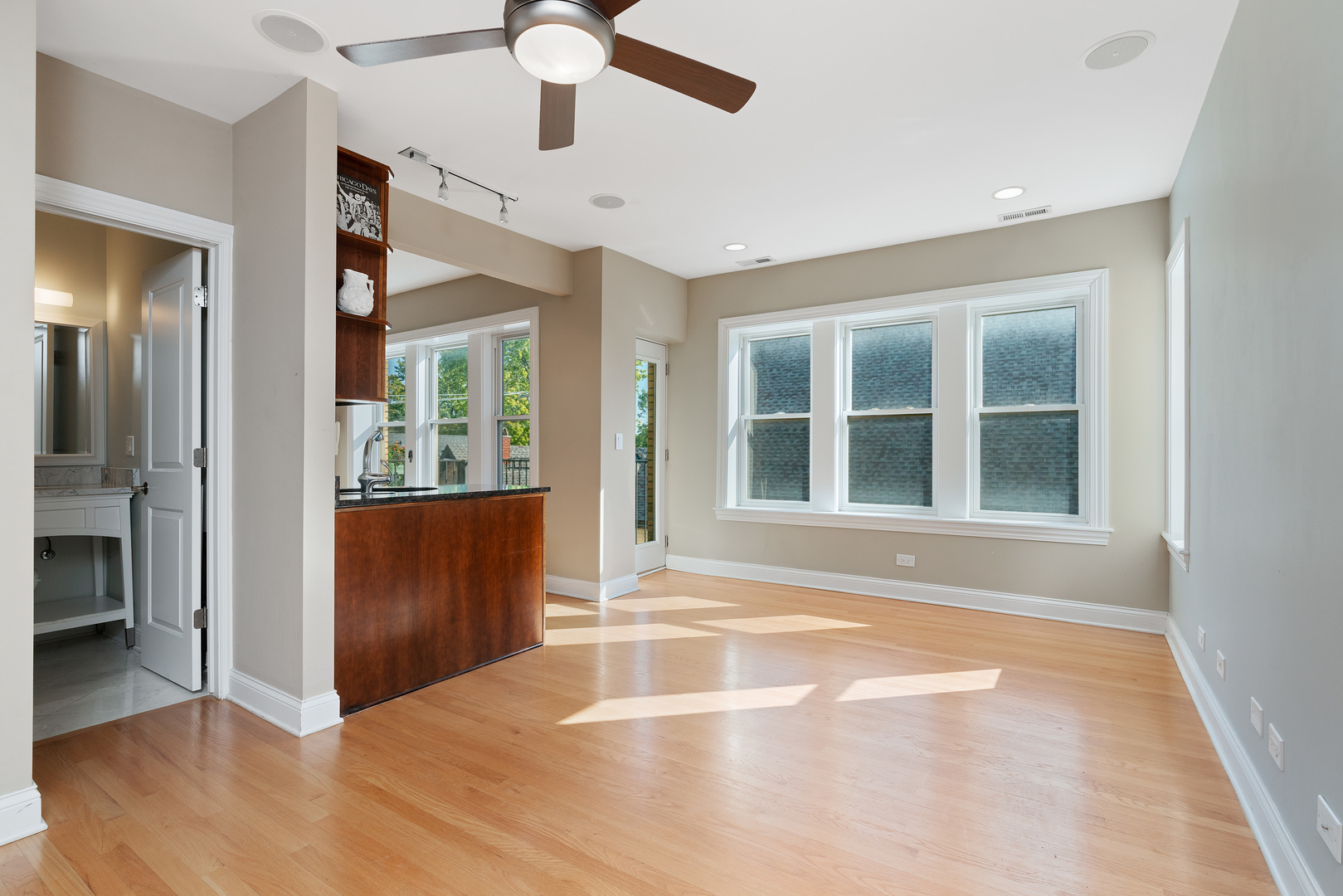 2142 West Addison Street, Unit 3B Chicago, IL 60618 - Photo 2 of 10 a view of an empty room with wooden floor and a window