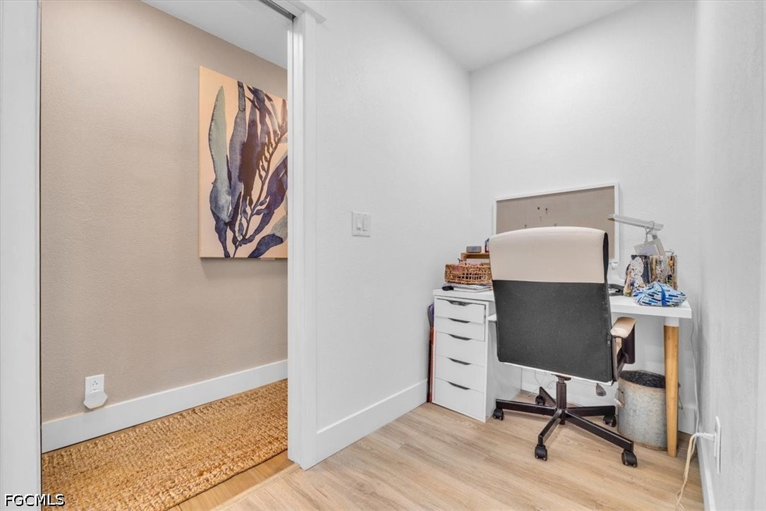 202 Ridgewood Avenue Clewiston, FL 33440 - Photo 39 of 50 a workspace with furniture and wooden floor
