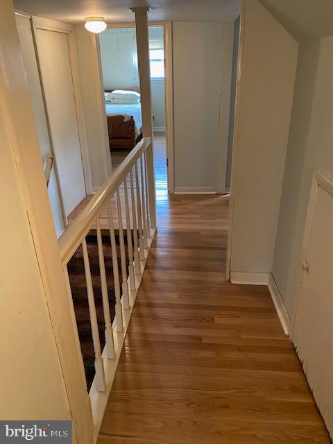 1497 Hilltop Road Pottstown, PA 19464 - Photo 12 of 25 a view of a hallway with wooden floor and staircase
