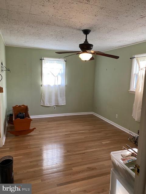 1497 Hilltop Road Pottstown, PA 19464 - Photo 14 of 25 a view of an empty room with window and wooden floor
