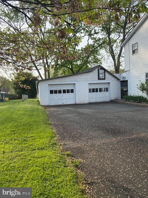 1497 Hilltop Road Pottstown, PA 19464 - Photo 2 of 25 a sign that is sitting in the grass with large trees