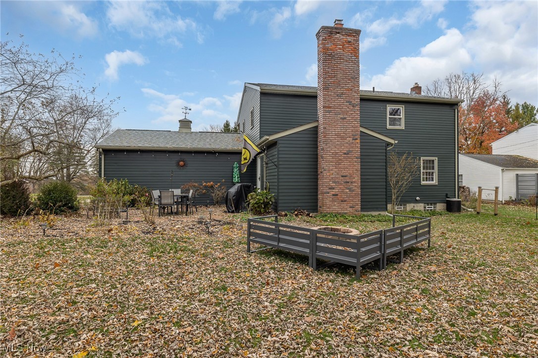 7711 Diagonal Road Kent, OH 44240 - Photo 43 of 45 Rear view of house with a chimney and a garden
