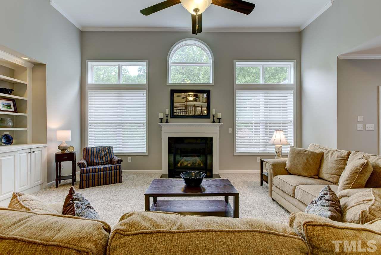 4001 Red Grape Drive Raleigh, NC 27607 - Photo 13 of 25 a living room with furniture and a fireplace