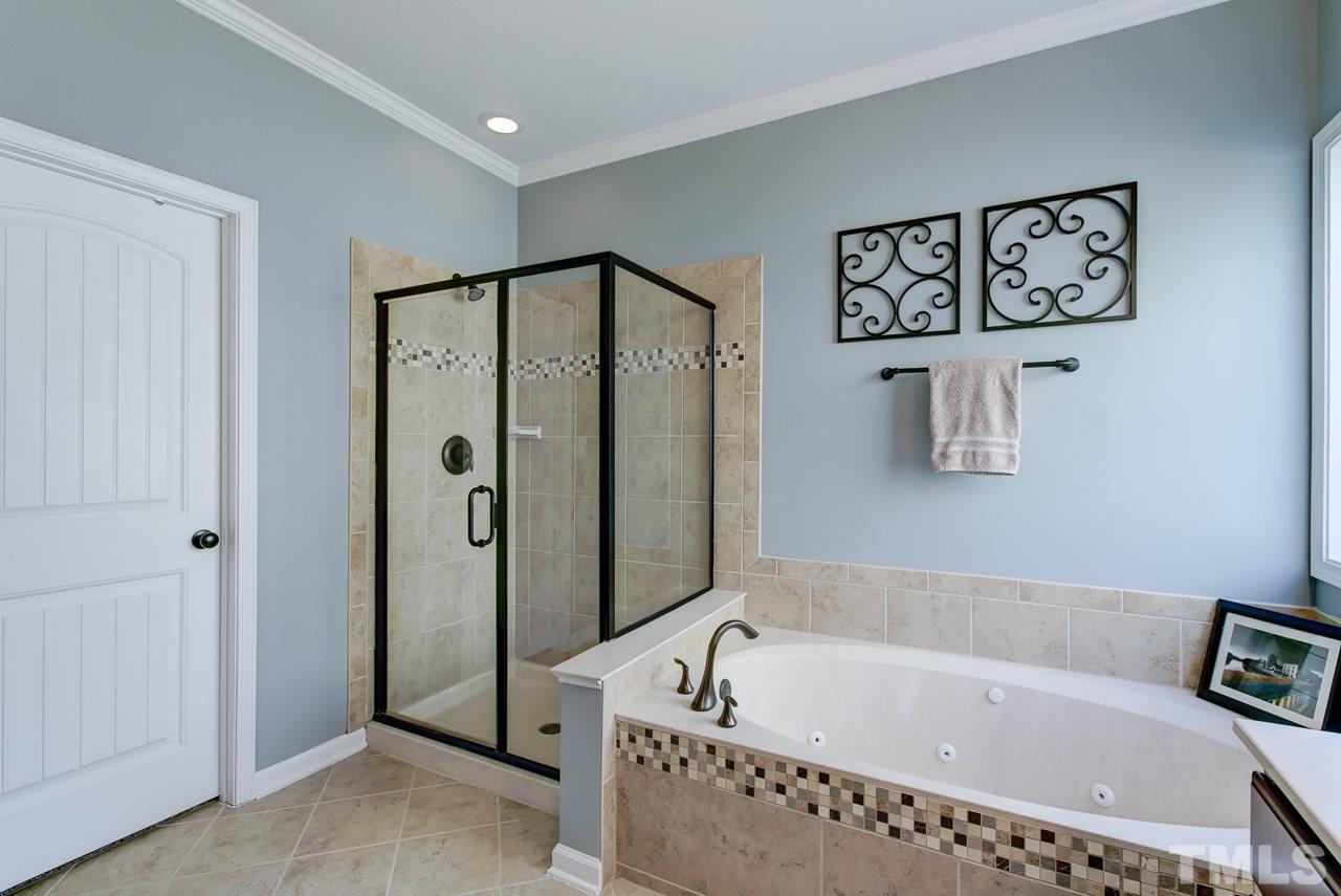 4001 Red Grape Drive Raleigh, NC 27607 - Photo 16 of 25 a bathroom with a bathtub and a shower