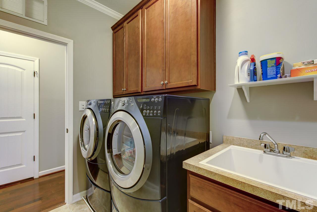 4001 Red Grape Drive Raleigh, NC 27607 - Photo 17 of 25 a utility room with sink dryer and washer