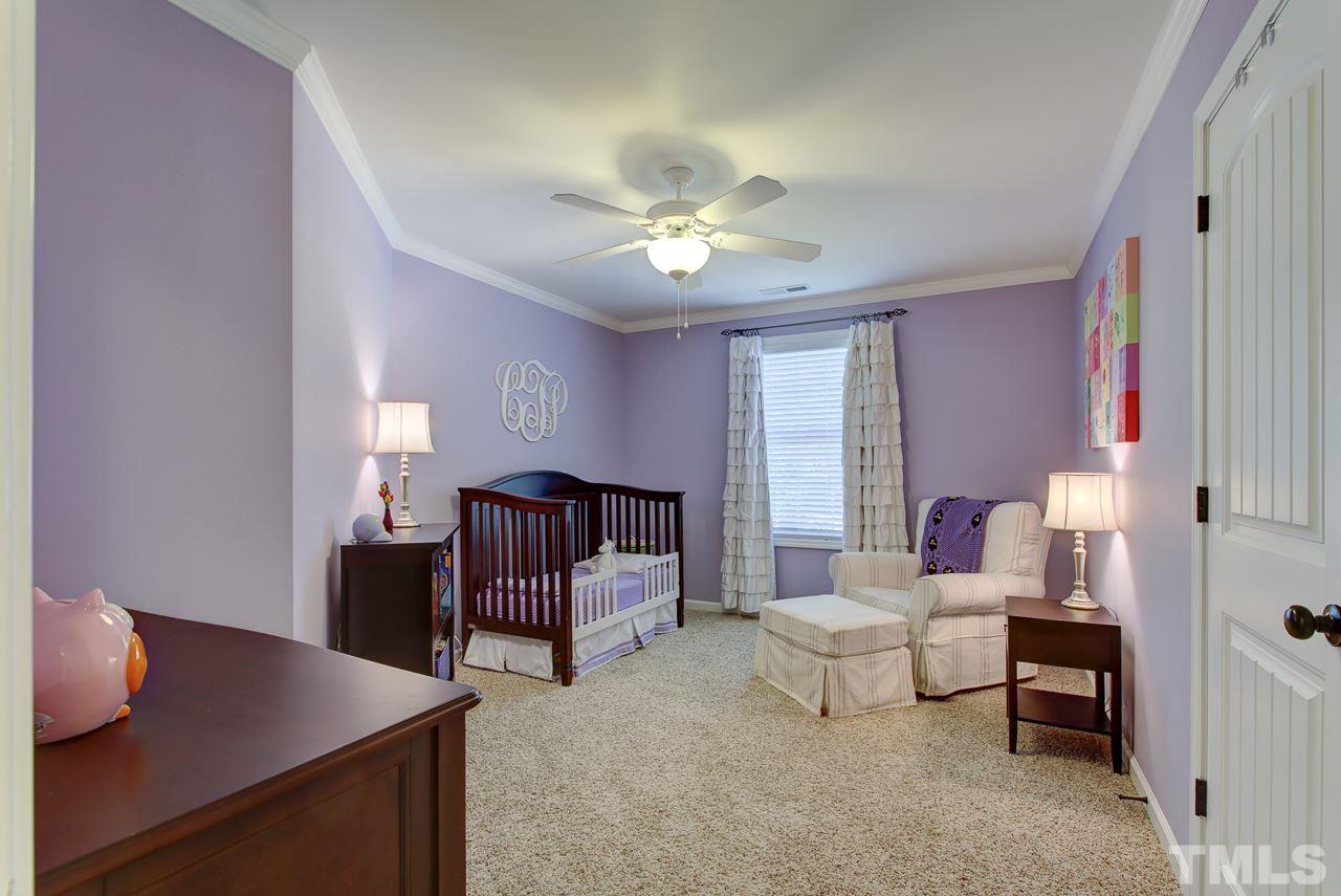 4001 Red Grape Drive Raleigh, NC 27607 - Photo 18 of 25 a living room with furniture and a chandelier